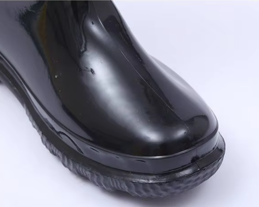 a092bfdc-7822-4703-8756-0930a4d9c5b3_zblízka-obrázok zaobleného špice na lesklom čiernom teplom PVC vodotesnom pracovnom čižme.png